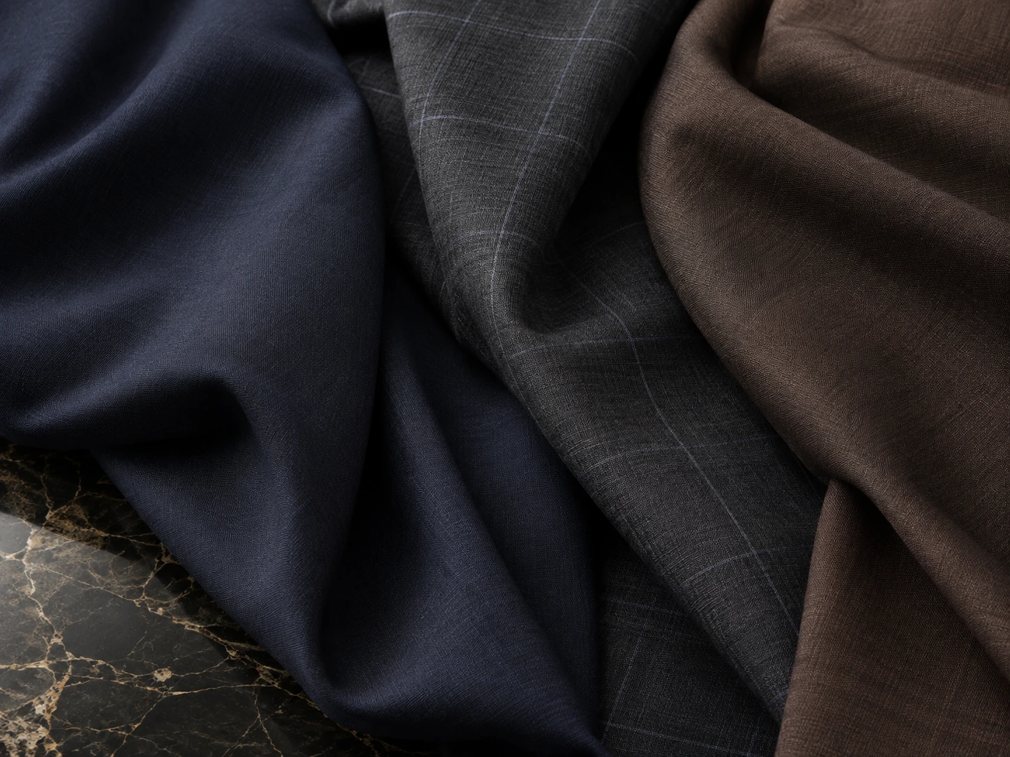 Navy and brown suiting fabrics in soft folds