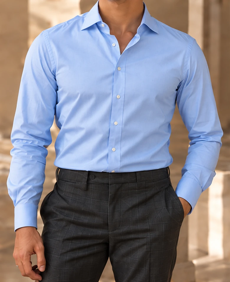 A light blue tailored cotton shirt tucked into dark checked trousers